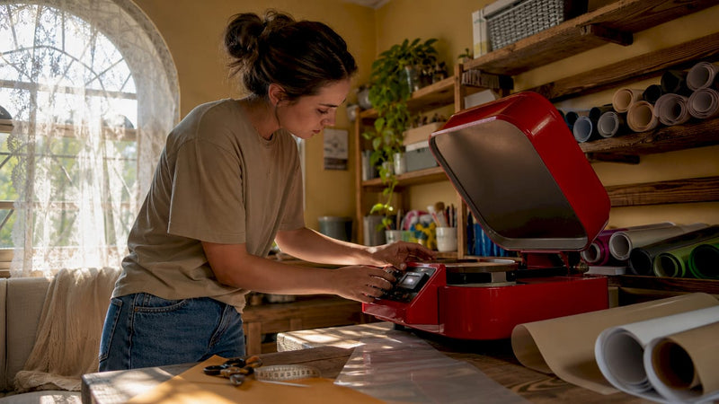 Woman adjusting heat press controls in crafting studio
