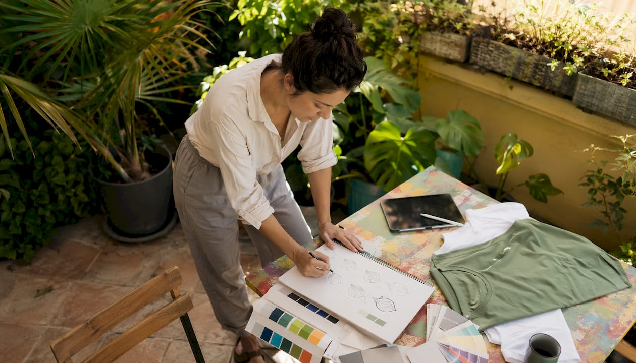Designer sketching custom merchandise concepts