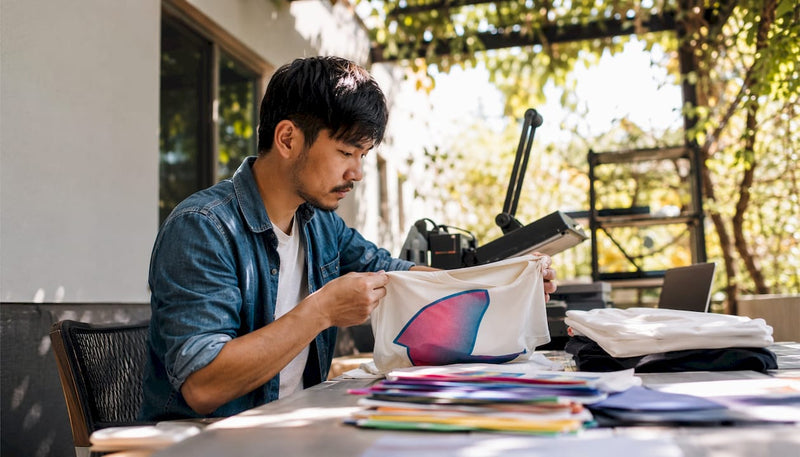 Business owner reviewing custom apparel samples