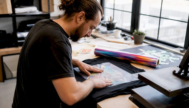Hands applying custom DTF transfer on t-shirt